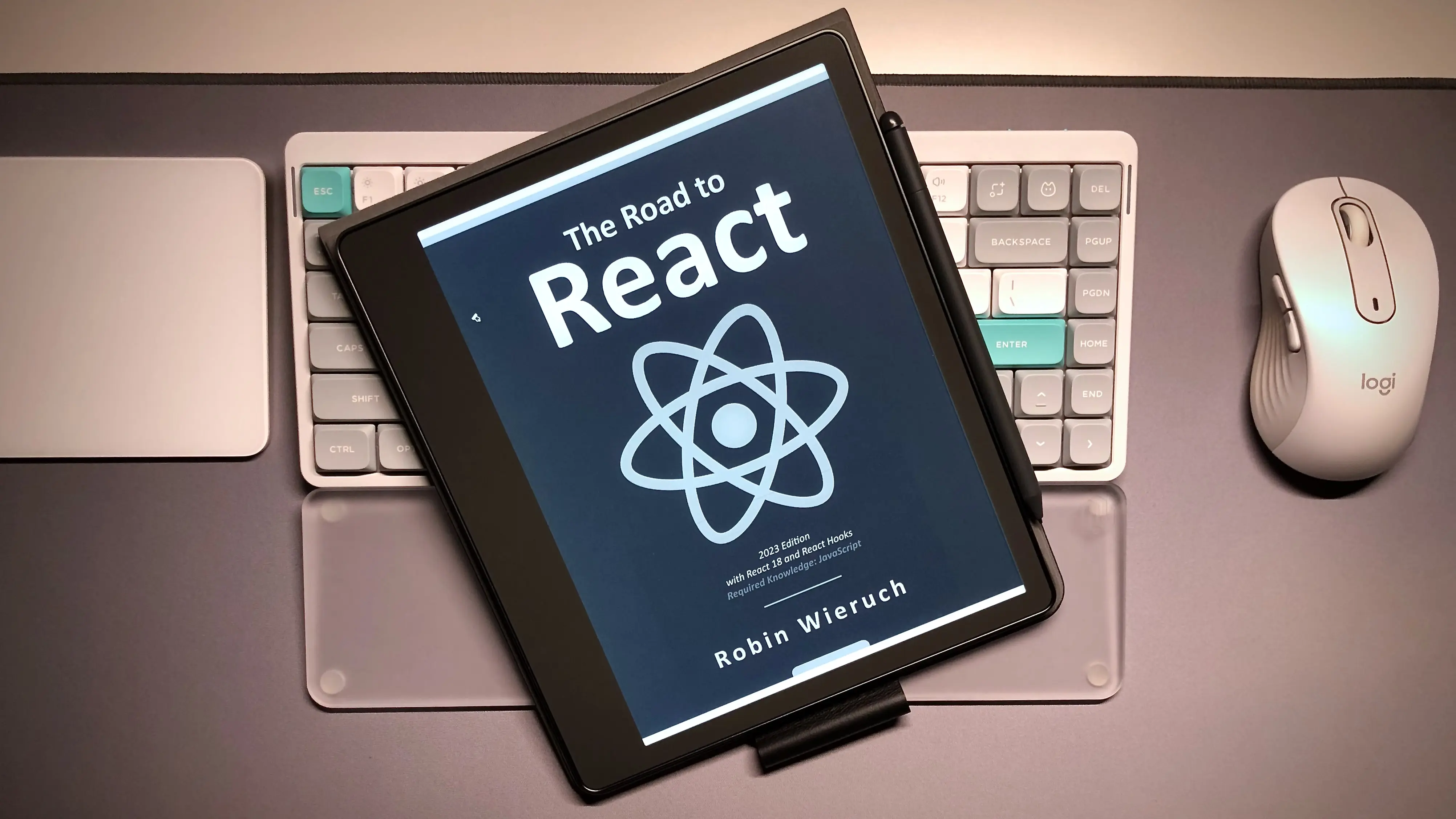 Post cover: The image shows an e-reader displaying the cover of the book "The Road to React" by Robin Wieruch.